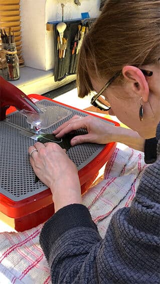 Glass being cut by hand for one of the butterfly panels