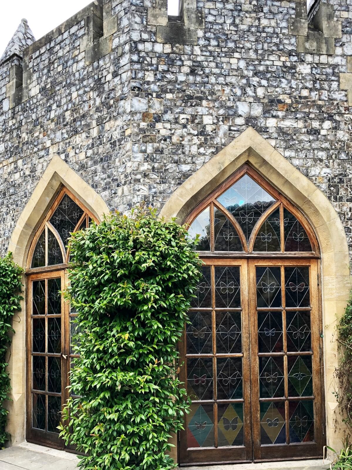 The conservatory doors viewed from the stone courtyard outside