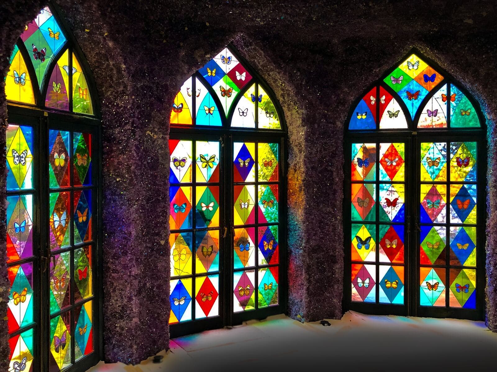 Three completed stained-glass double doors viewed from inside the conservatory