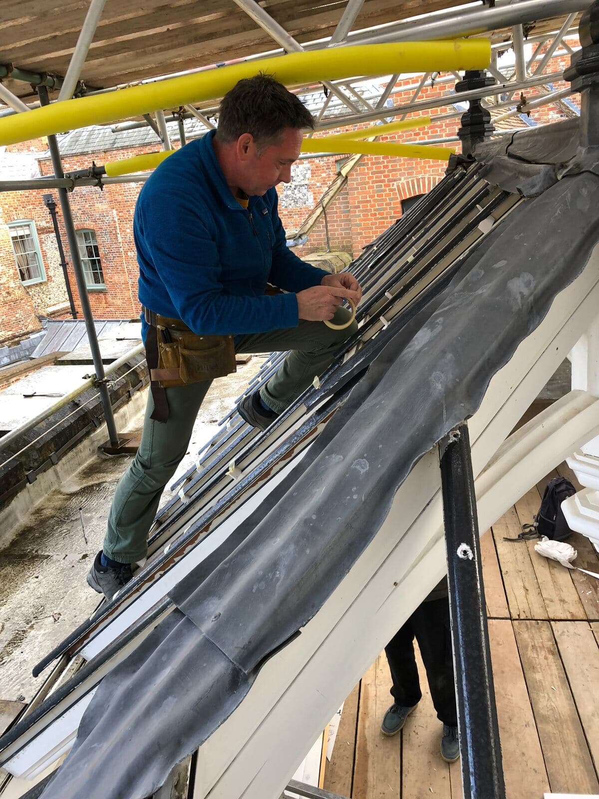 A member of the studio team installing panels into the conservatory roof