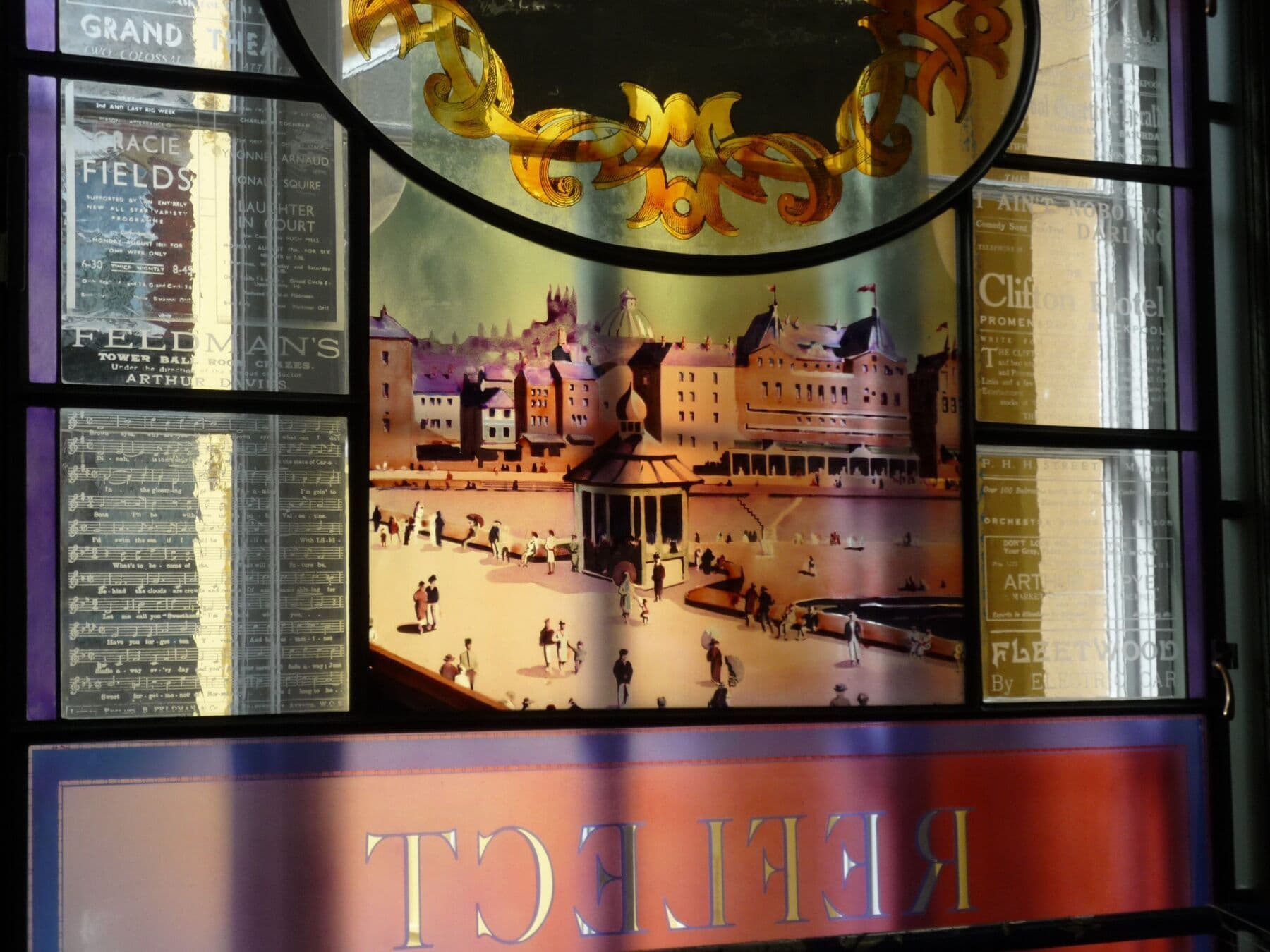Detail of a completed library window with historic imagery and reflected lettering