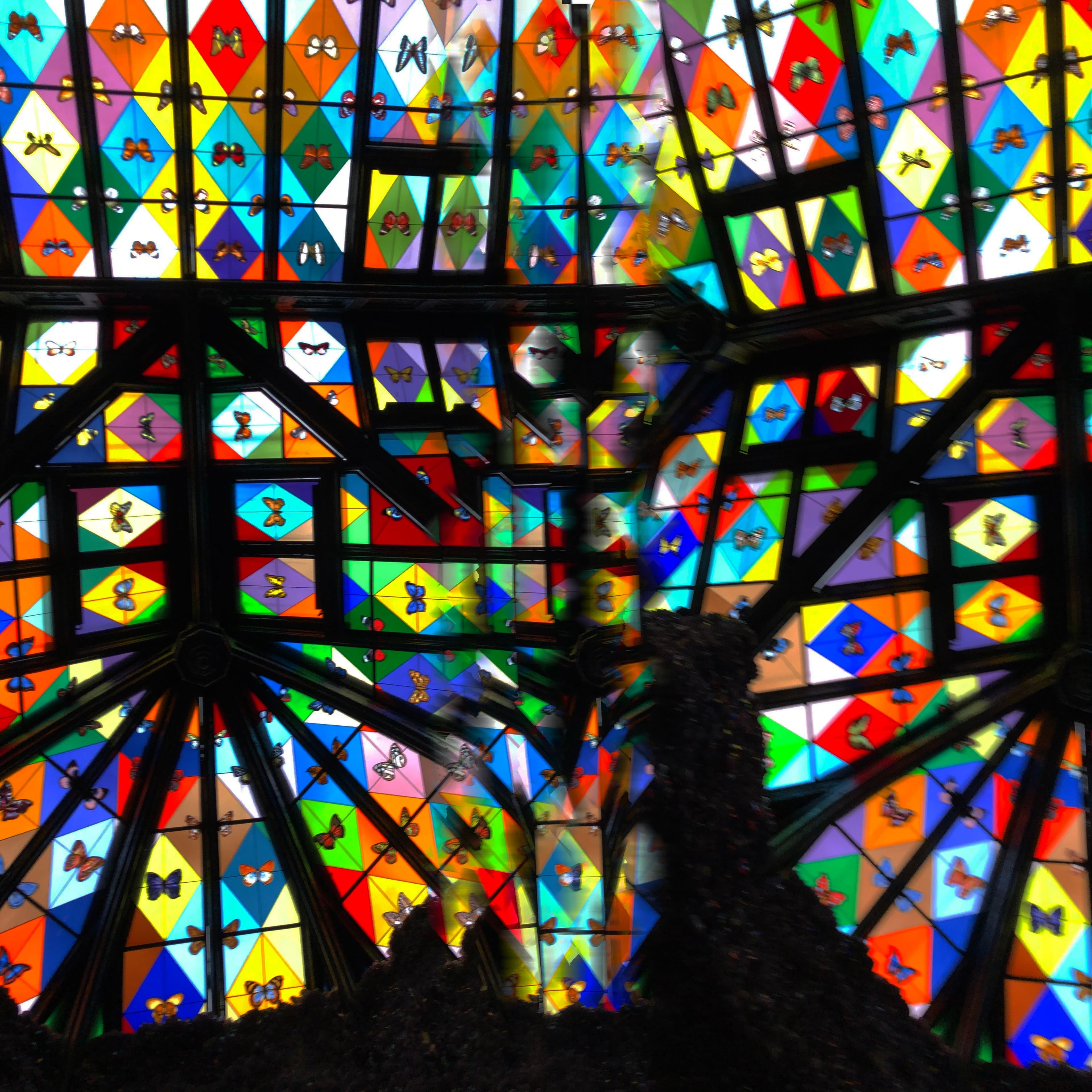 view of stained glass ceiling with colourful butterflies arranged like a kaleidoscope
