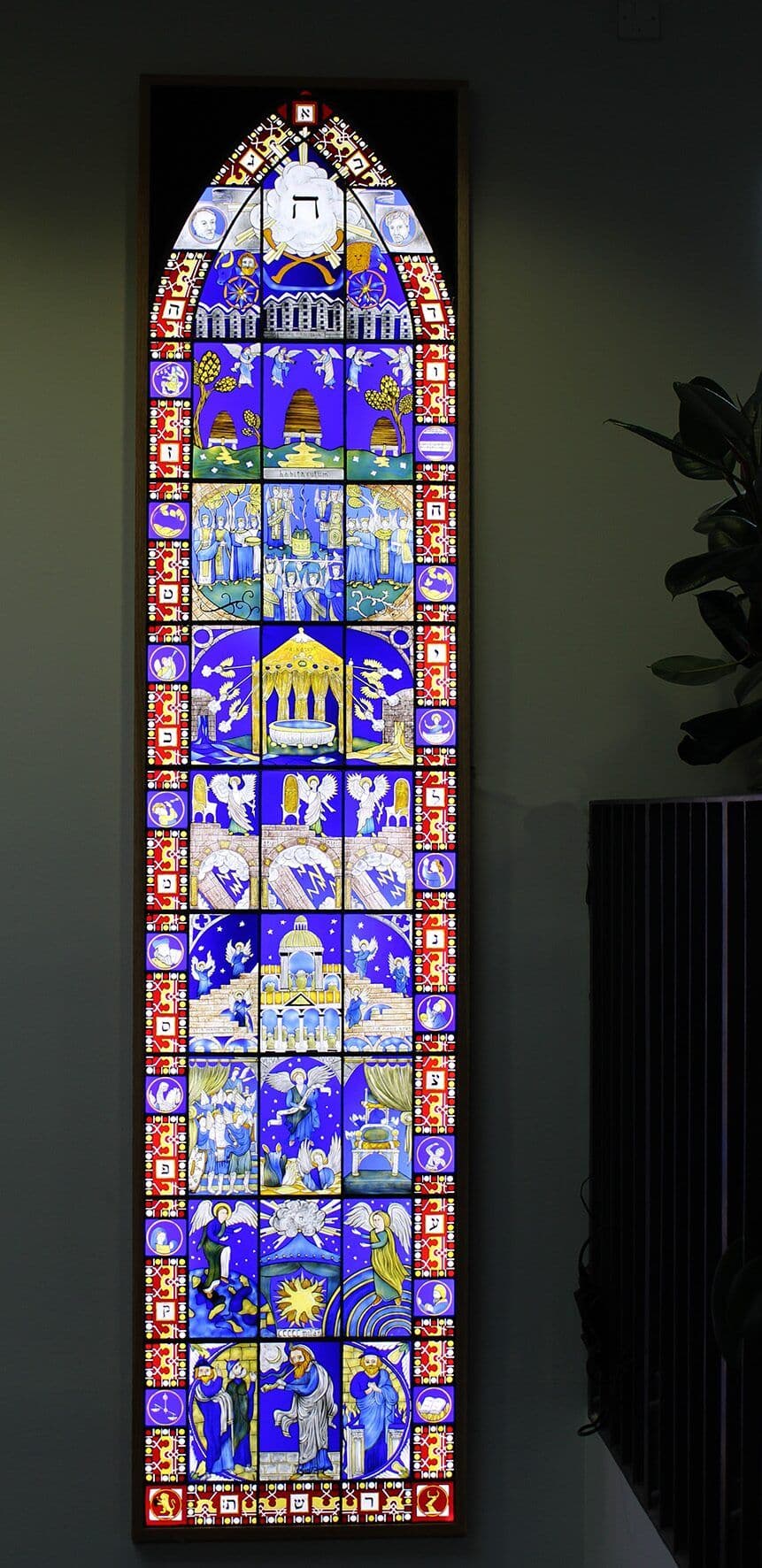 The completed Hymn to the Creator of Light window installed in its illuminated wall-mounted light box