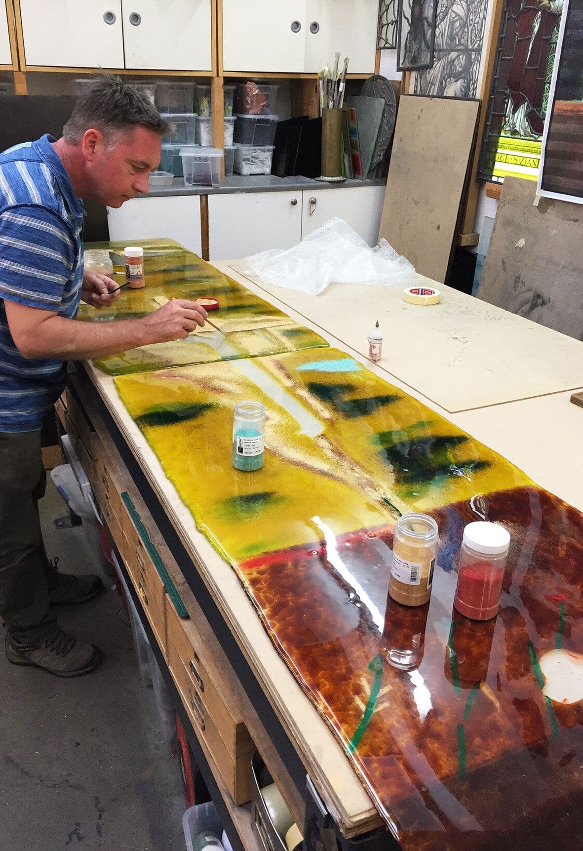 Richard Paton working across the full glass panel in the studio