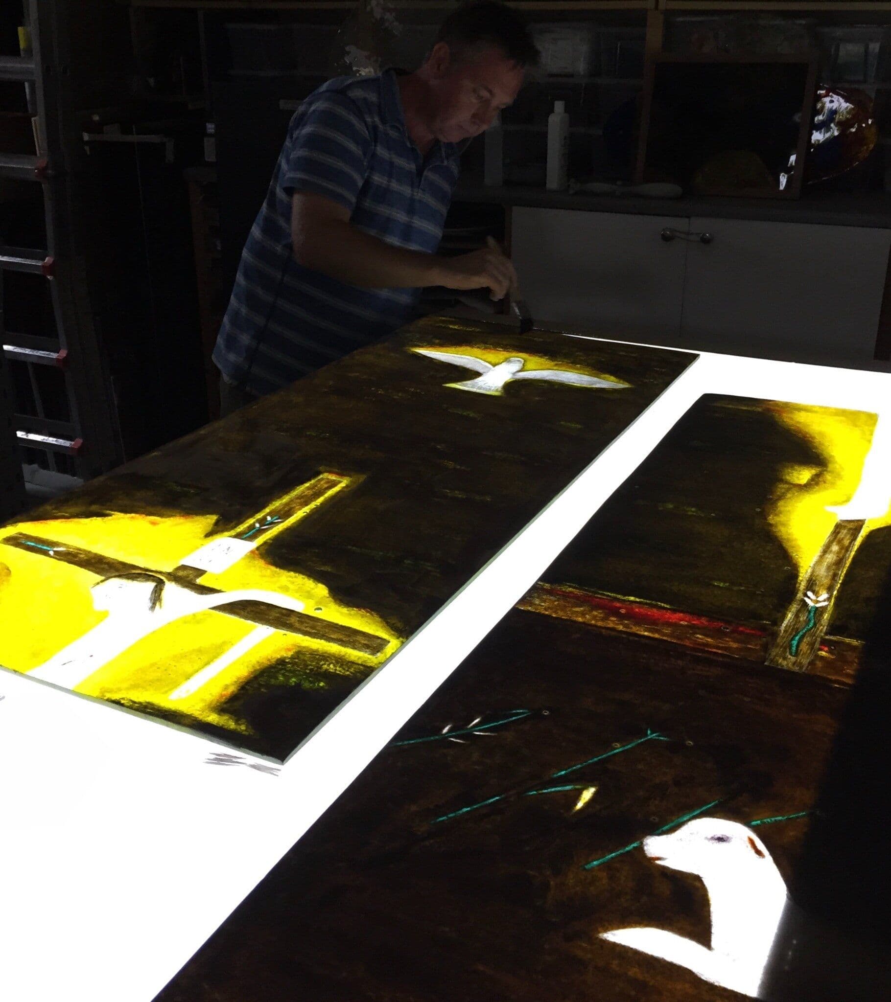 Richard Paton working over the full-size Craigie Aitchison window layout in the studio