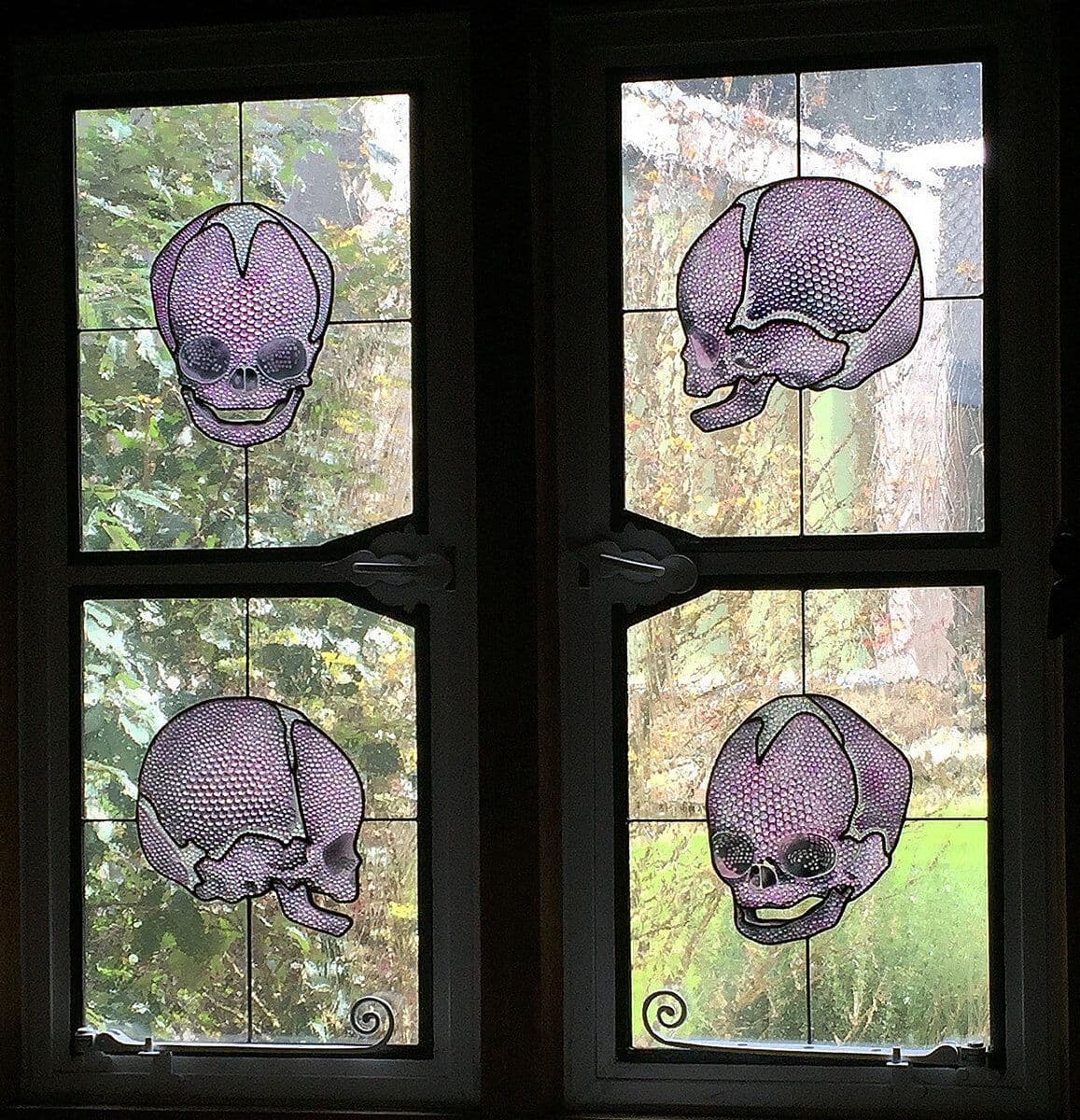 Four purple skull windows installed in dark timber frames